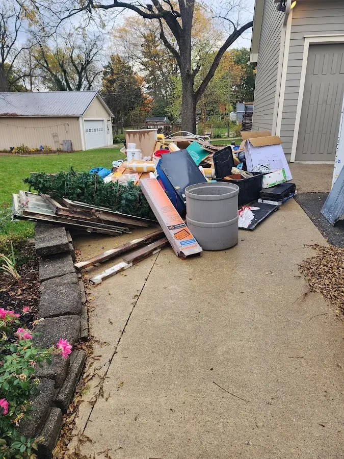 Dumpster being loaded with debris for Residential Dumpster Rental in Mapleton